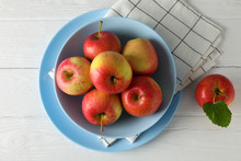 Composition With Plate And Apples On White Wooden Background, Top View