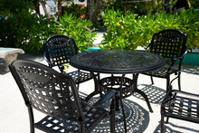 Outdoor Cafe With Black Metal Table And Chairs On Tropical Island