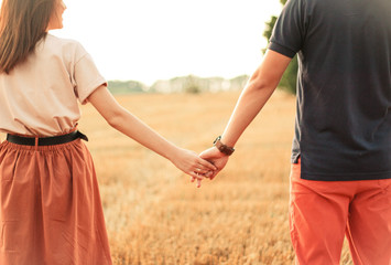 married couple walking in the field