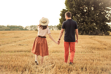 Wall Mural - married couple walking in the field