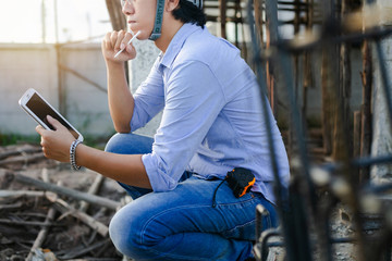 Wall Mural - Male architect inspecting building house construction  worker at development site