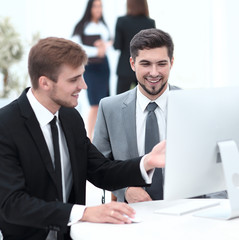 Poster - employees are talking sitting behind a Desk