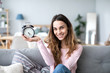 © BestForYou - Happy beautiful young woman holds alarm clock.