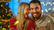 © Gorodenkoff - On Christmas Eve Handsome Man and Beautiful Woman Embracing and Smiling. Lovely Couple Have a Good Time Celebrating with Shooting Confetti.