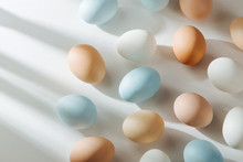 Natural Colored Eggs With Sunlights. Compositions In Pastel Colors. Easter Consept.  Flat Lay, Top View