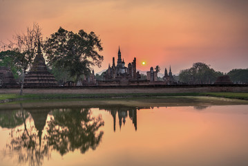 Wall Mural - Wat Maha That temple at Sunset in Sukhothai historical park, A World Heritage site, in Central Thailand	