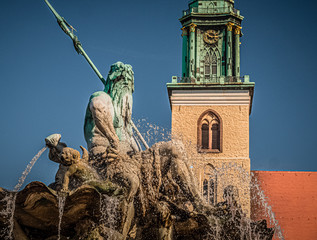 Germany, Berlin - August 23, 2019: Neptune Fountain with a view of the church tower.