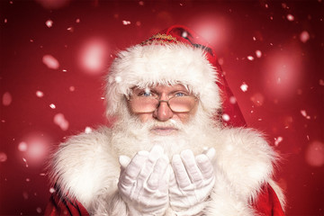 Real Santa Claus portrait. Red studio background.