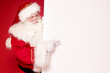 © neonshot - Real Santa Claus holding white empty board.