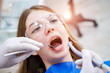 © Vadim - Attractive young woman in stomatology clinic with male dentist. Healthy teeth concept.