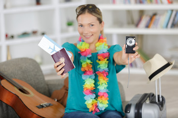 woman showing her passport ticket and digital camera