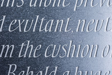 Generic Words Carved From Dark Stone With Sideways Lighting.