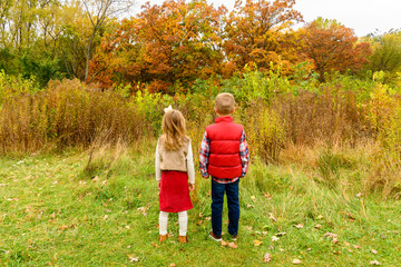 Two children boy and girl looking away 