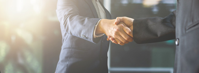 Wall Mural - successful negotiate and handshake concept, two businessman shake hand with partner to celebration partnership and teamwork, business deal