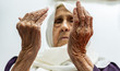 © Diya - Old muslim woman praying for god to bless her and give her strength