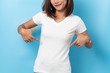 © suriya - Portrait of asian woman in a blank white T-shirt on blue background Mock-up