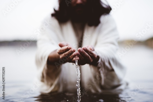 Closeup shot of Jesus Christ holding water with his palms