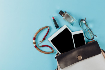 Wall Mural - Contents of woman's bag.Top view of Women bag and lady stuff with copyspace on pink background