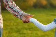 © Kostia - parent holds the hand of a small child