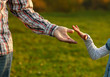 © Kostia - parent holds the hand of a small child