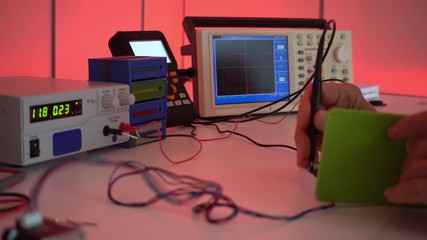 Sticker - Development of a servo design in a robotics laboratory. Workbench with an oscilloscope, power supply and tester