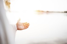 Closeup Shot Of Jesus Christ Landing A Hand For Help With A Blurred Background