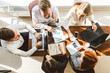 © xartproduction - A team of young businessmen working and communicating together in an office. Corporate businessteam and manager in a meeting.