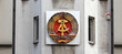 National emblem of East Germany (DDR) on a wall in Berlin near Checkpoint Charlie, Germany - August 2015
