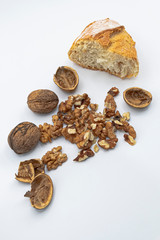 Wall Mural - Freshly harvested organic wallnuts and bread, white background.
