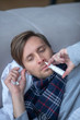 © zinkevych - Top view of sick exhausted man using nasal spray
