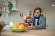 © zinkevych - Dark-haired man reading news on tablet and drinking tea
