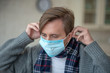© zinkevych - Sick man wearing protective mask while suffering from infection