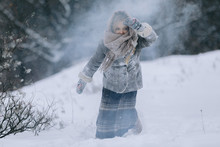Cute Little Child Girl In The Forest In Winter. Snowing And Snowstorm
