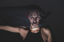 Woman In A Black Veil With Dark Makeup And An Earring In Her Nose. Halloween Dead Bride Costume. Portrait Of An Ominous Witch In Front Of A Coven In A Dark Studio.