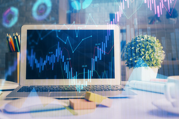 Double exposure of chart and financial info and work space with computer background. Concept of international online trading.