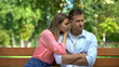 Girlfriend apologizing boyfriend sitting outdoor, relations misunderstanding