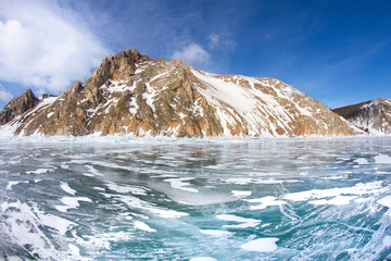 View of beautiful drawings on ice from cracks and bubbles of deep gas on surface of Baikal lake in winter, Russia