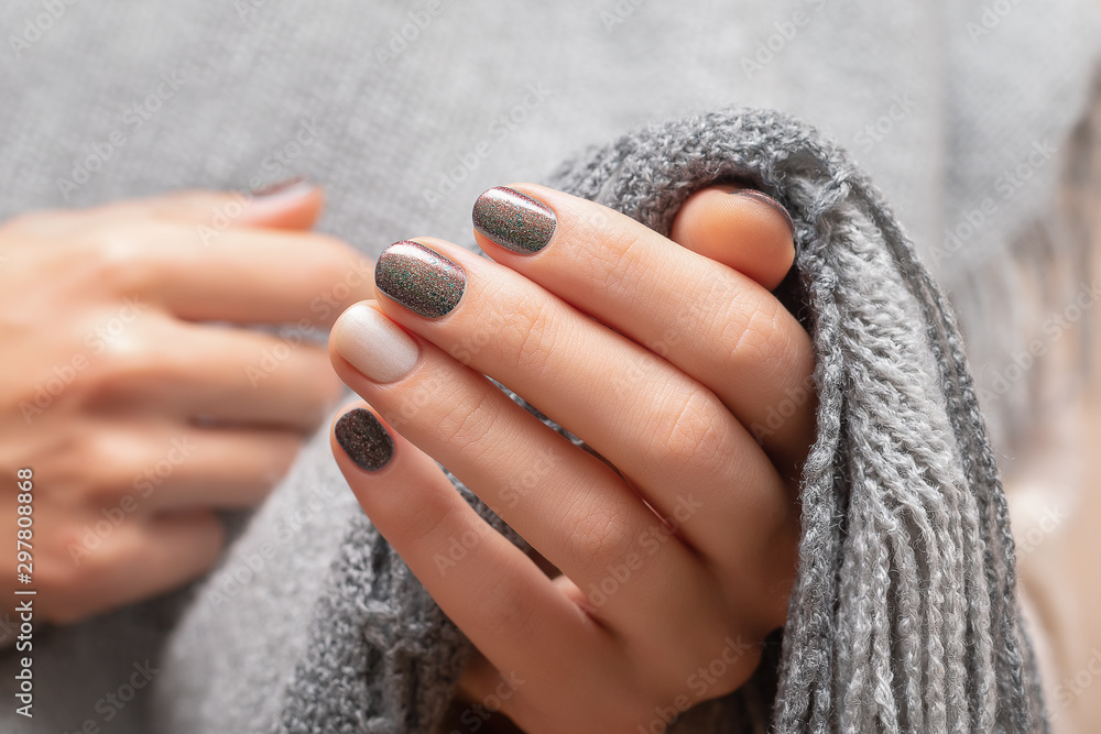 Fotografering Female hands with brown glitter nail design.