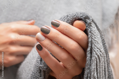 Cuadros en Lienzo Female hands with brown glitter nail design.