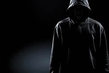 Wall Mural - Thief in black clothes on grey background