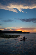 Daybreak At A Central Florida Lake With A Kayaker Rowing.