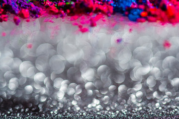 Wall Mural - abstract background with defocused glitter effect and colorful powder, template with silver bokeh and vibrant color powder, copy space image