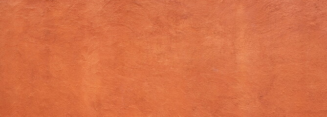 Abstract panorama image of Orange clay wall grunge texture background for interior decoration.