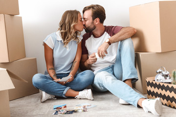 Canvas Print - Photo of romantic couple drinking coffee and kissing while sitting