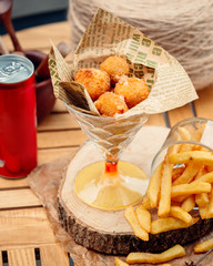 Canvas Print - cheese balls with french fries on the table