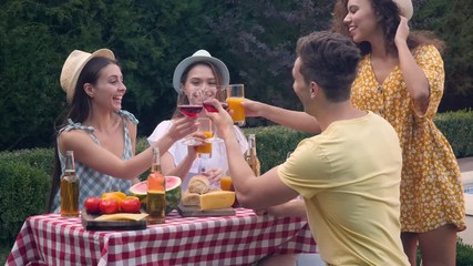 Canvas Print - Happy friends with drinks having fun at barbecue party outdoors. Picnic time