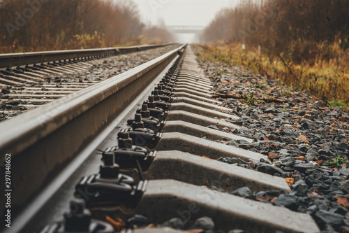 Fotografía modern railway goes into foggy distance