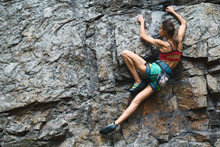 Sports Woman With Slim Fit Body Climbing The Rock Having Workout In Mountains. Rock Climbing Hard Moves