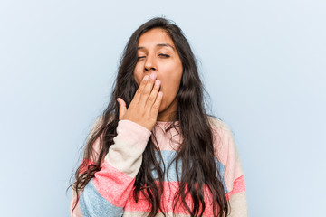 Wall Mural - Young fashion indian woman yawning showing a tired gesture covering mouth with him hand.