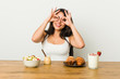 © Asier - Young curvy woman taking a breakfast showing okay sign over eyes